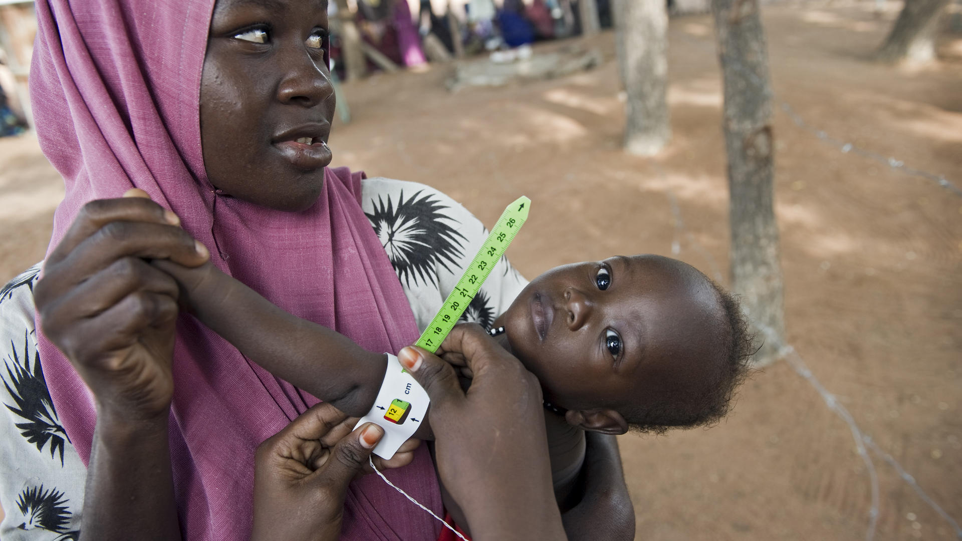 Mother holds baby while undergoing medical tests