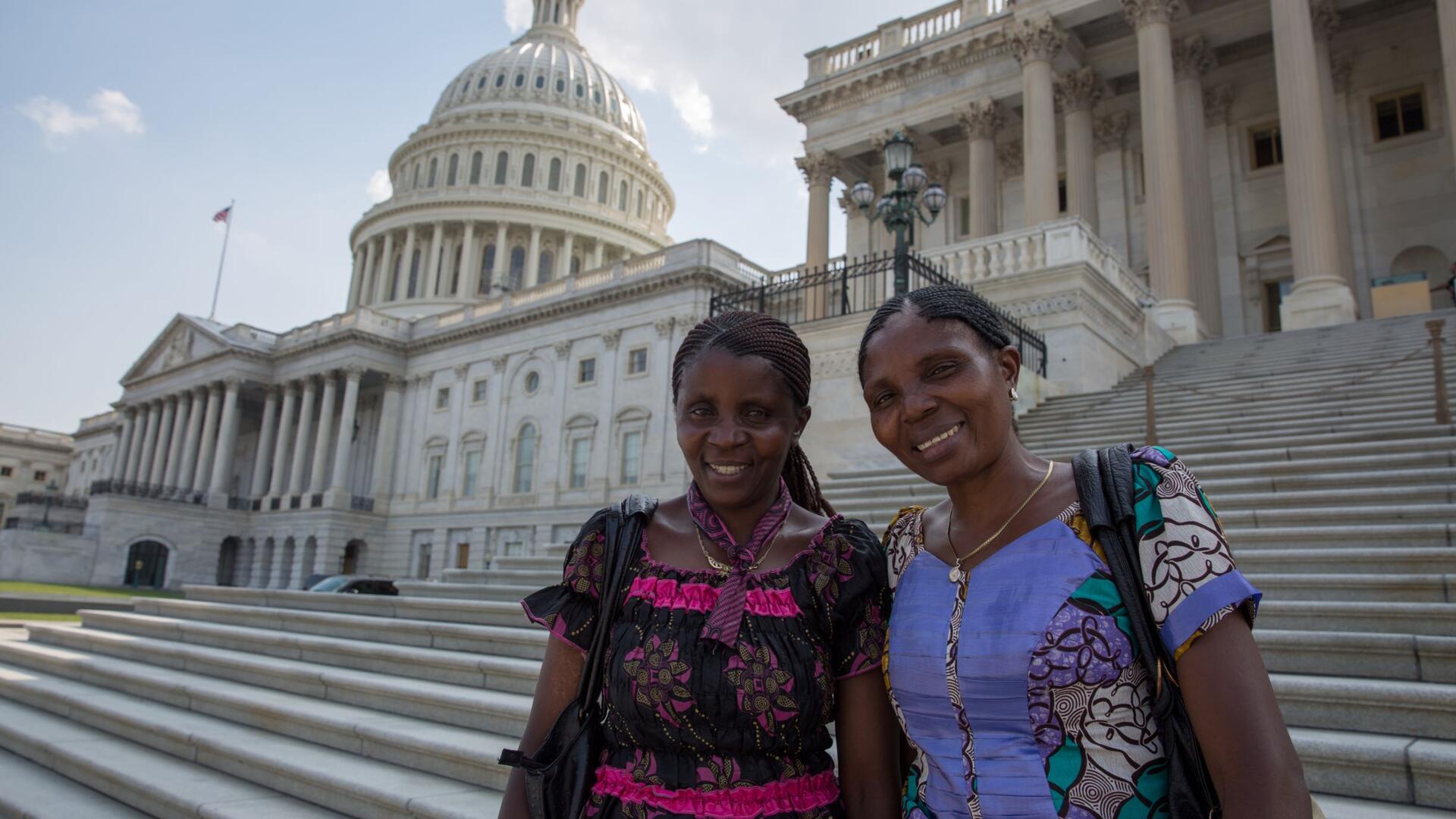 Two female women's rights activists from the Democratic Republic of Congo stand on the steps of the U.S. Capitol on a visit to Washington, DC in 2016