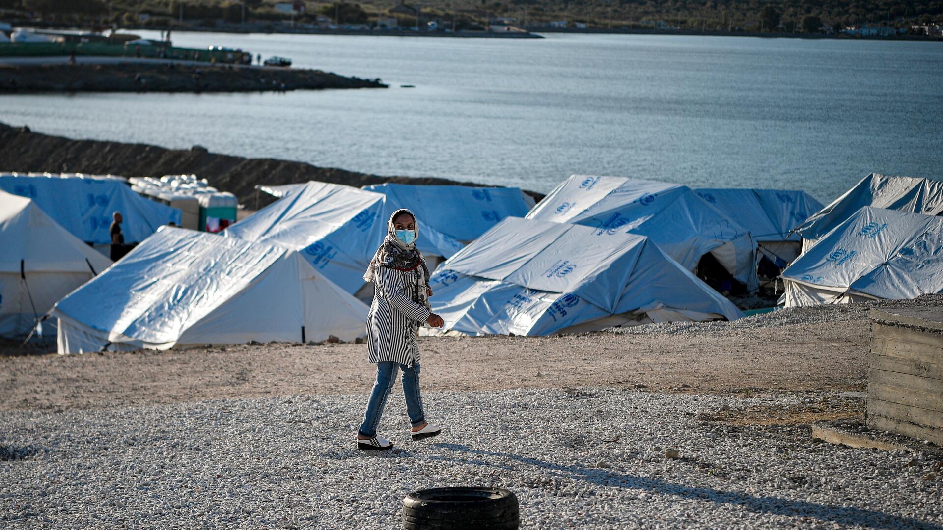 Rahima walks past tents in the refugee camp her family was relocated to on the Greek island of Lesbos.
