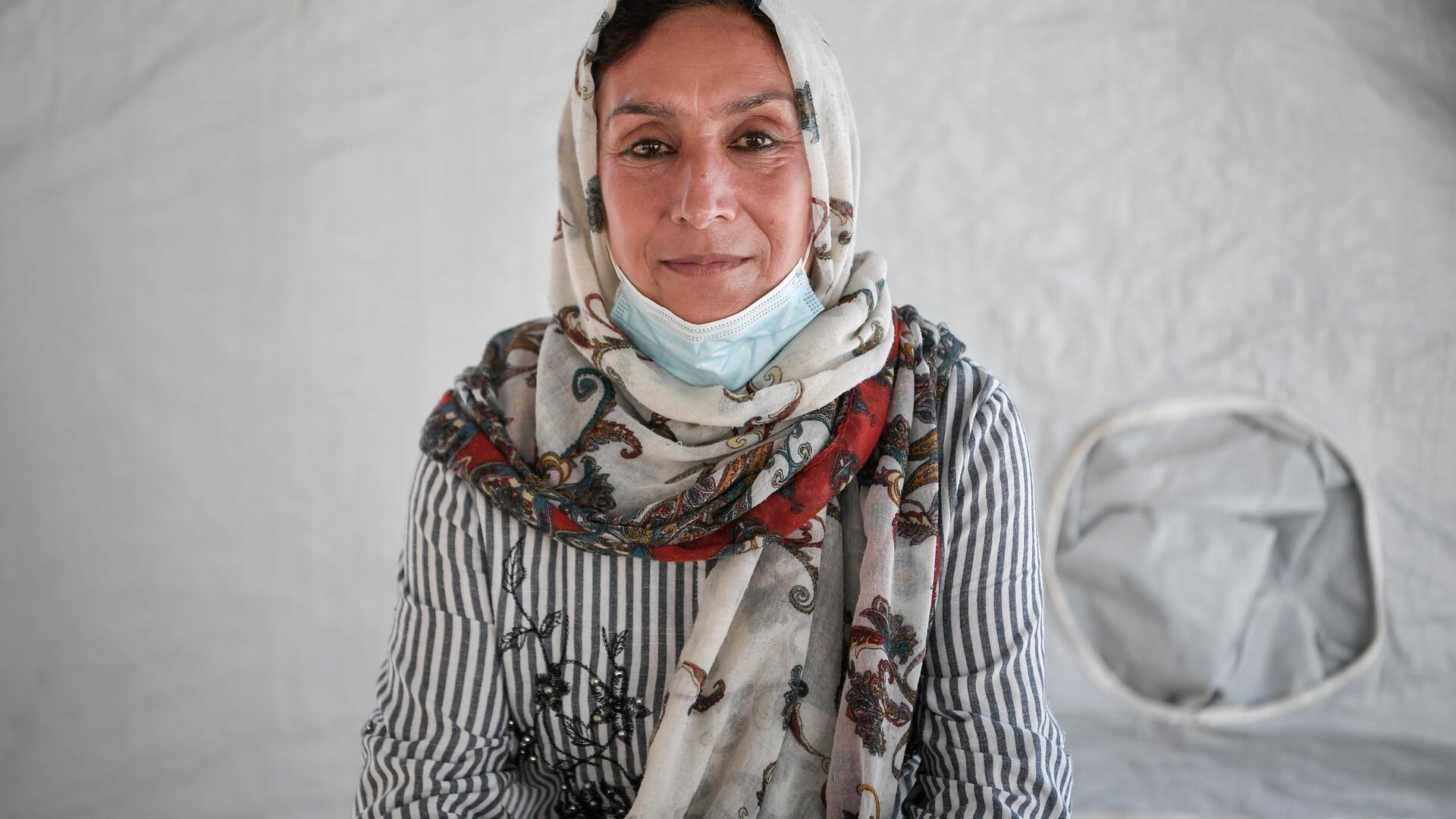 Rahima Yousofi is an Afghan refugee and International Rescue Committee volunteer in Greece helping to fight COVID-19 Rahima Yousofi, 45, sits inside a tent in a refugee camp on the Greek island of Lesbos