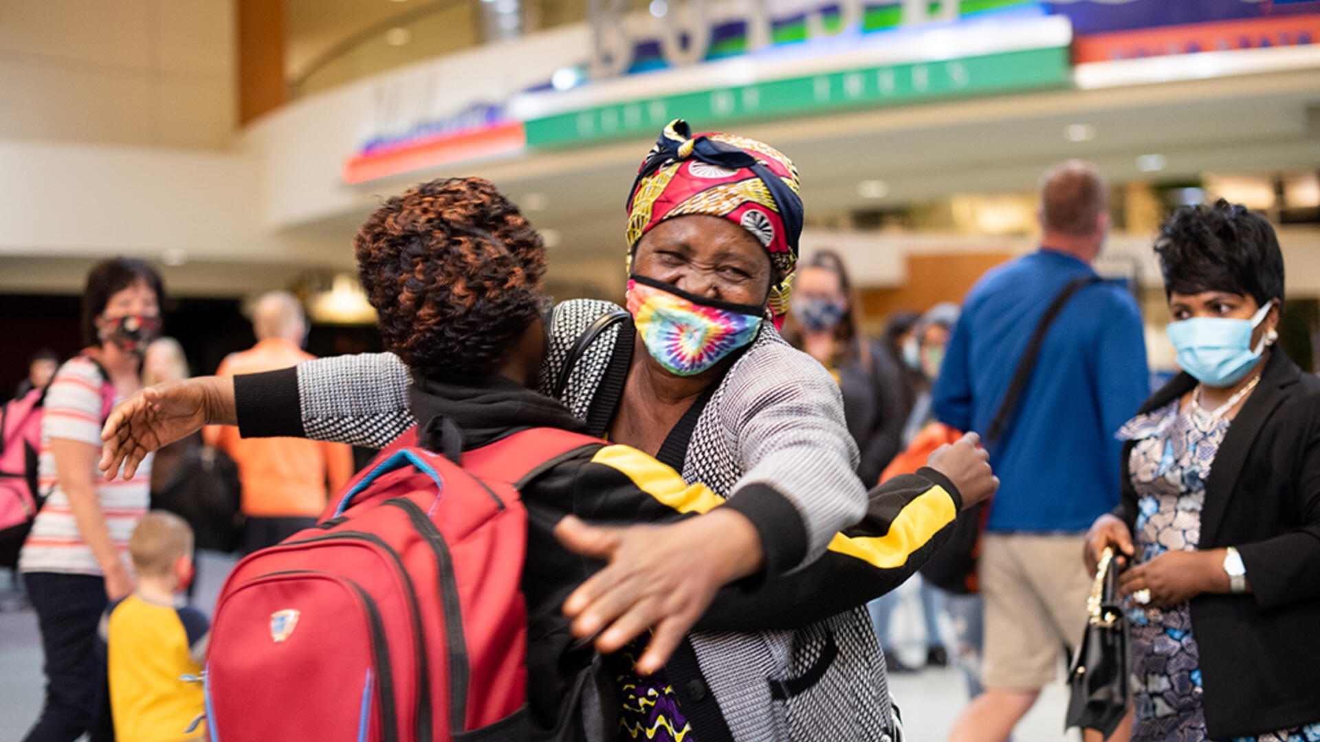 Wanyema Mitambo hugs her grandchild after being separated Wanyema Mitambo, wearing a mask, hugs her grandchild in the Boise Airport