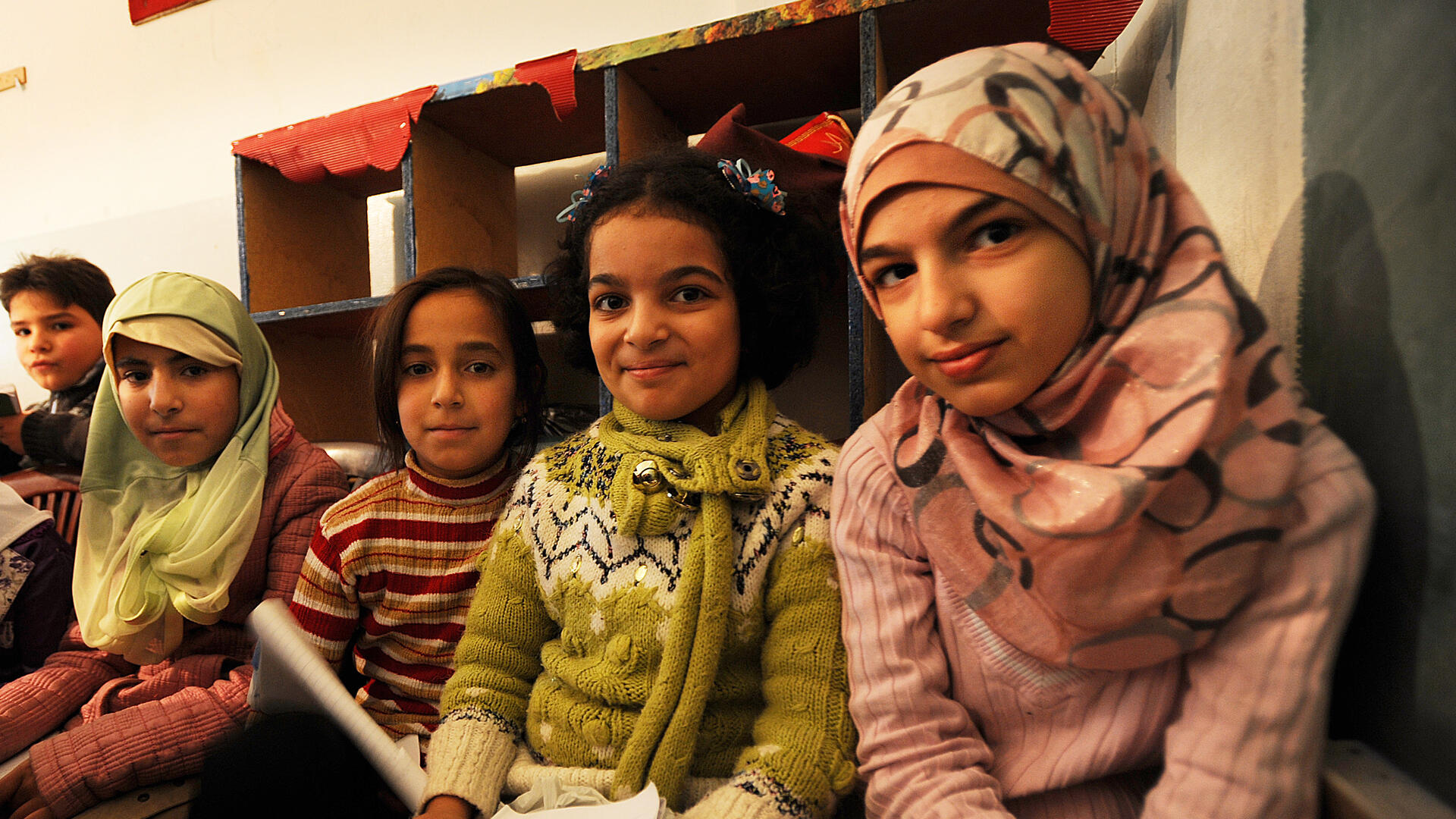 Four young Syrian girls sit in a makeshift school in Berkayel, Lebanon. 