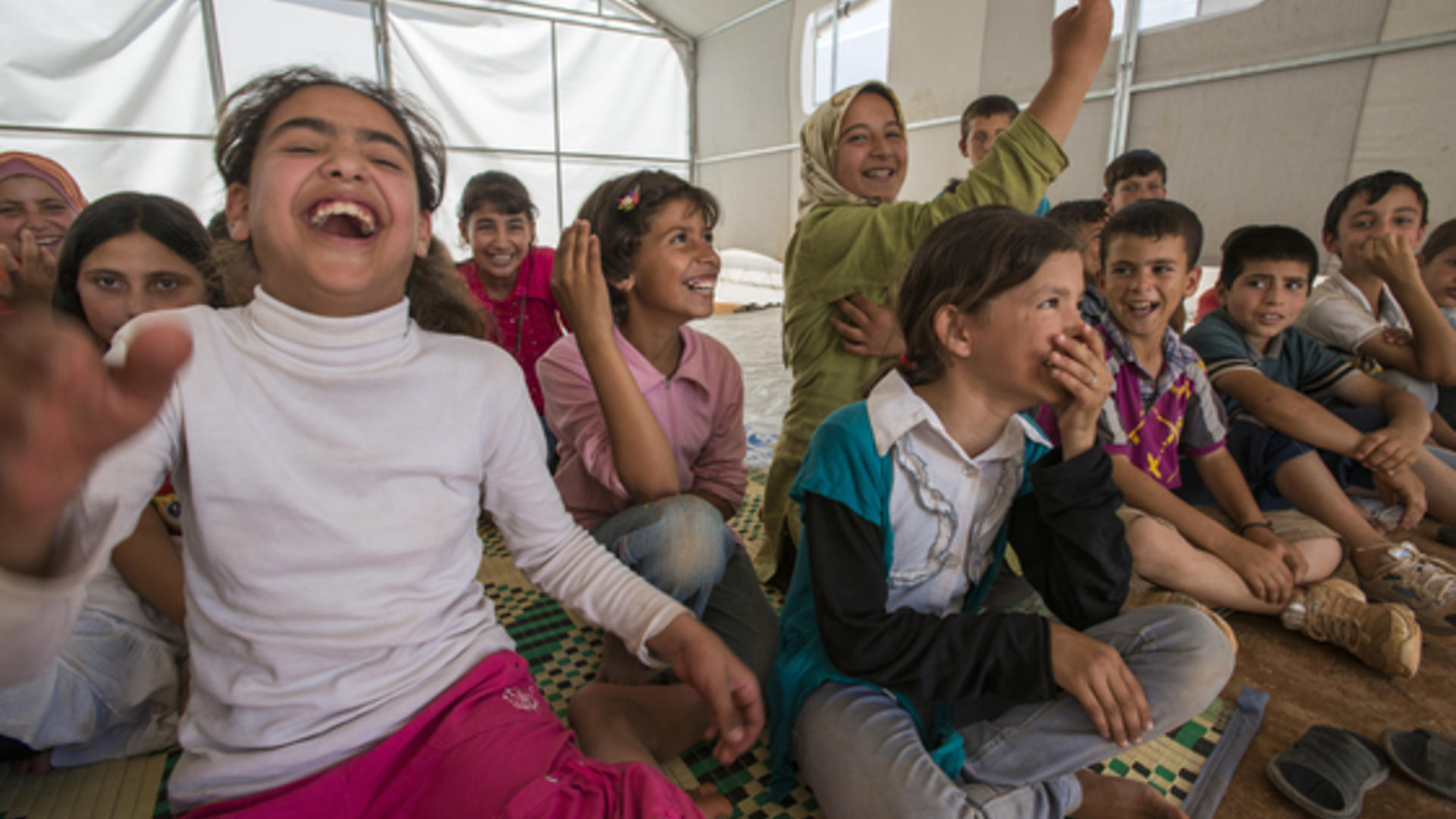 Syrian children in an IRC healing classroom tent