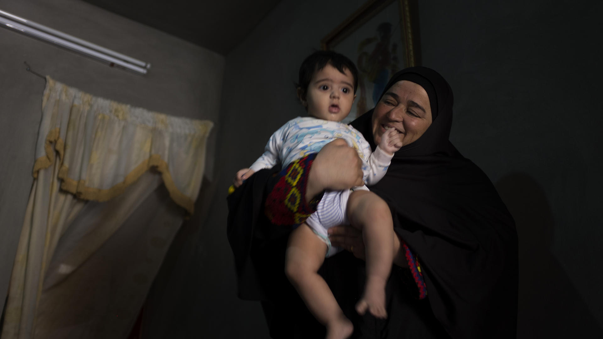 Syrian woman with her young grandson in Jordan