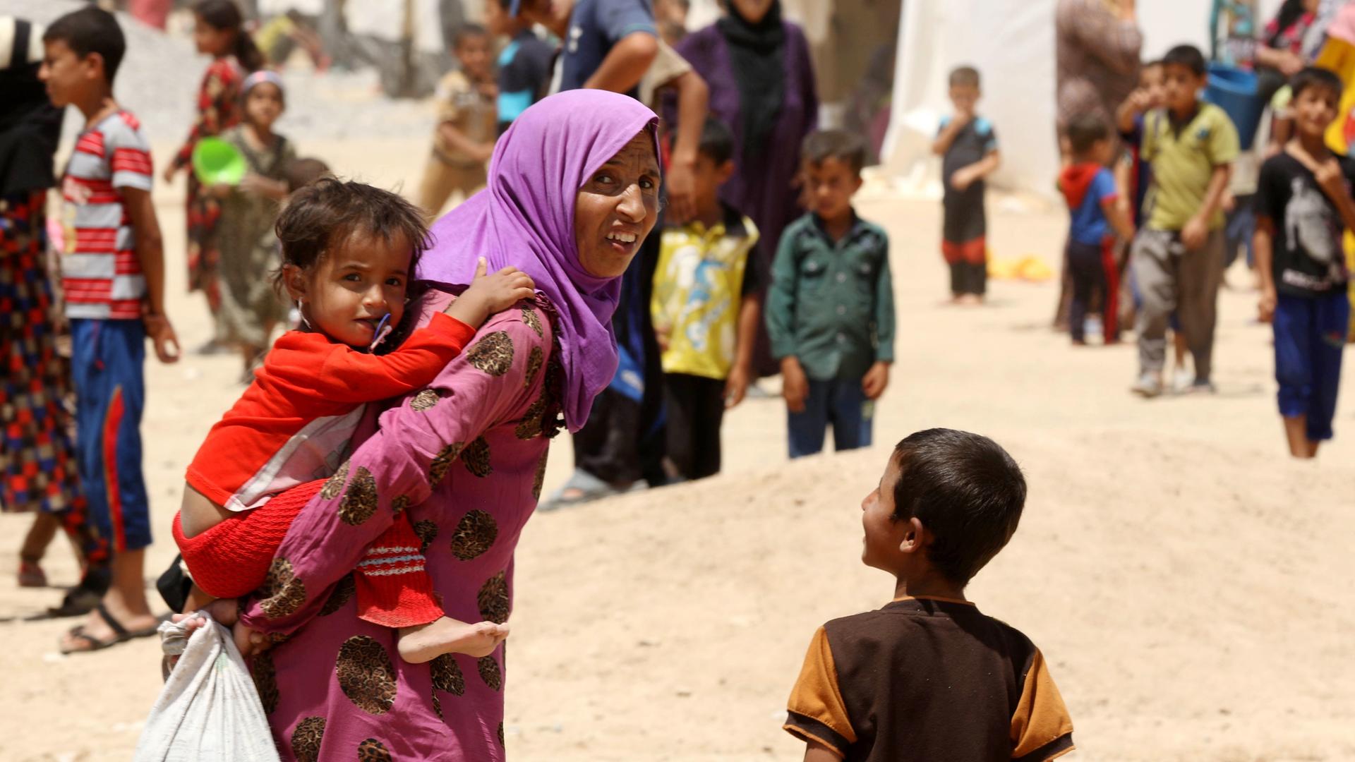 Iraqi family forced to flee home on the outskirts of Mosul to escape from ISIS violence. Iraqi family forced to flee home on the outskirts of Mosul to escape from ISIS violence.