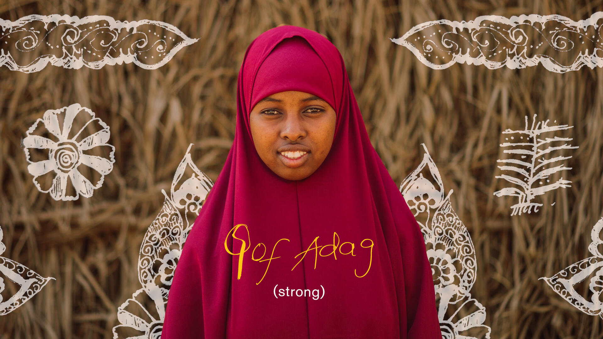 Suleykha Isaac Mohammed, wearing maroon, smiles for the camera. There is text on the photo that reads "strong" in English and Somali. 
