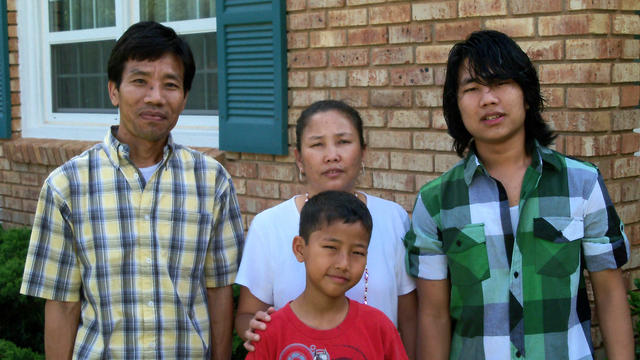 After almost 17 years of living in a bamboo hut in a refugee camp in Nepal, Bal and Meena Rai moved into their own home in Abilene in February, 2010. Father, mother, and two sons pose for picture in front of their new Abilene home which the IRC helped them move into.